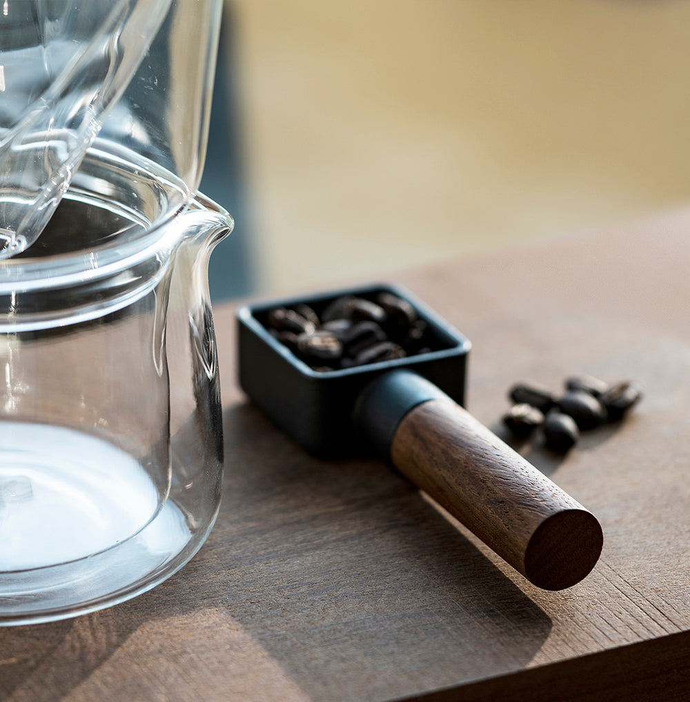 A cast iron coffee scoop with walnut wood handle. 10 grams per scoop.