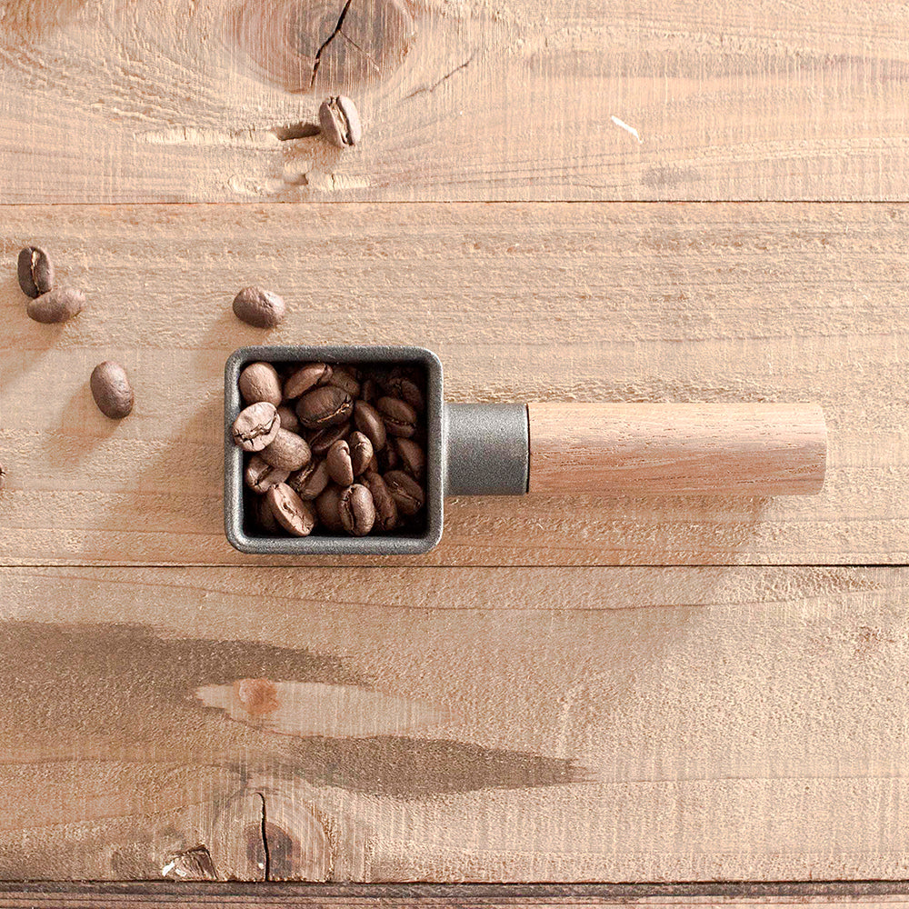 A cast iron coffee scoop with walnut wood handle. 10 grams per scoop.