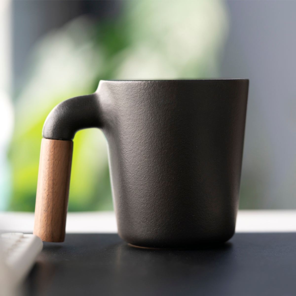 HMM signature product. Unique ceramic with walnut wood mug.