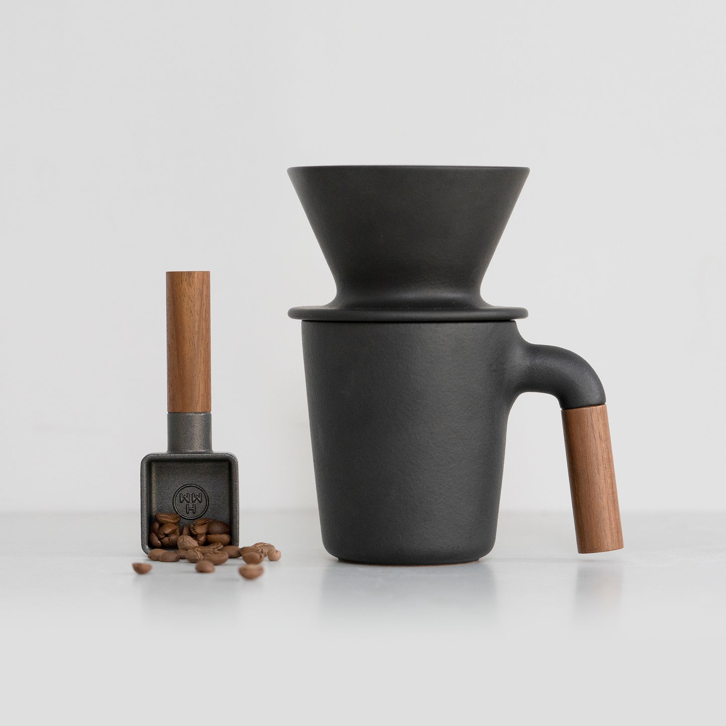Ceramic coffee set - mug, dripper, and coffee scoop.