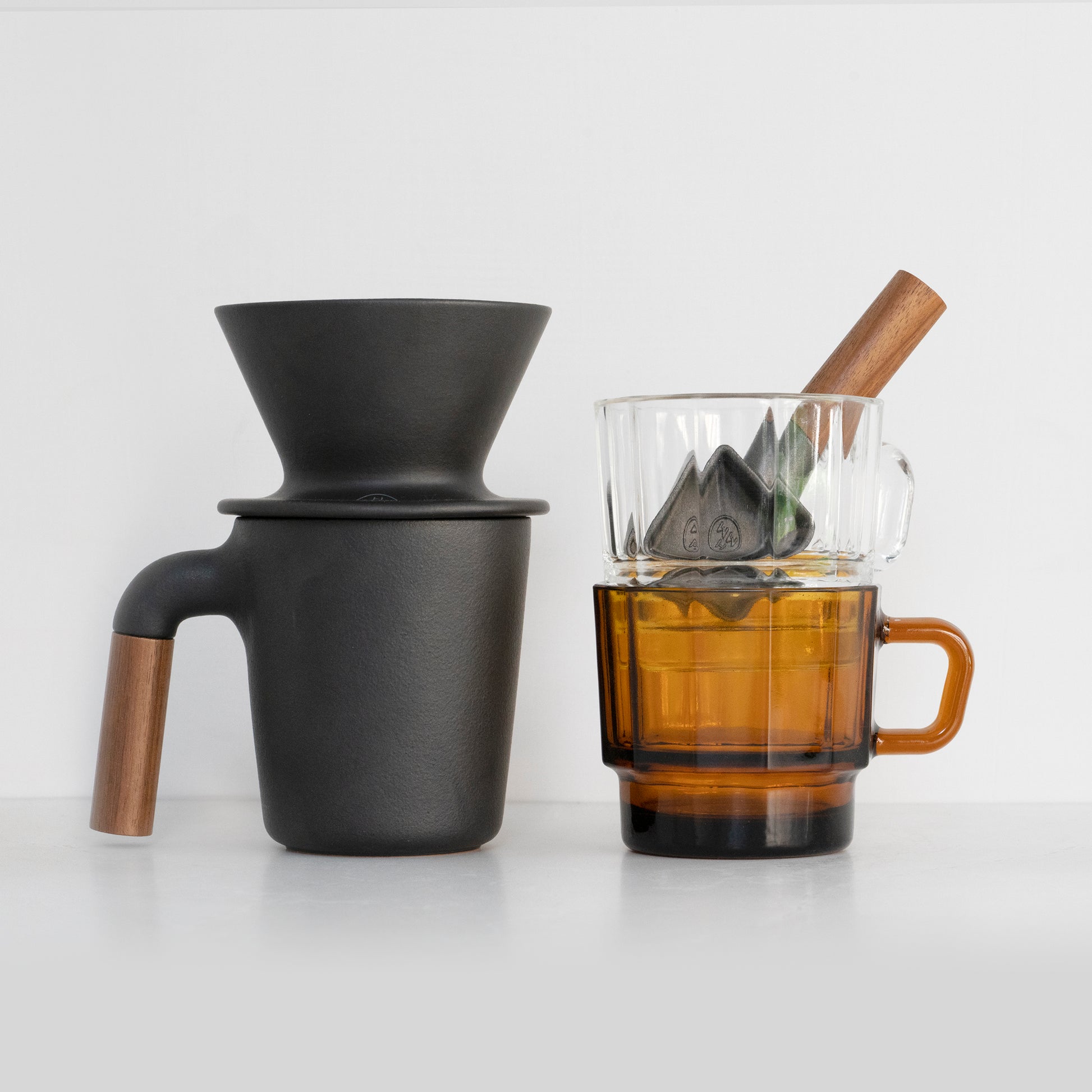 HMM coffee collection with ceramic mug, dripper, cast iron coffee scoop and recycled glass cup.