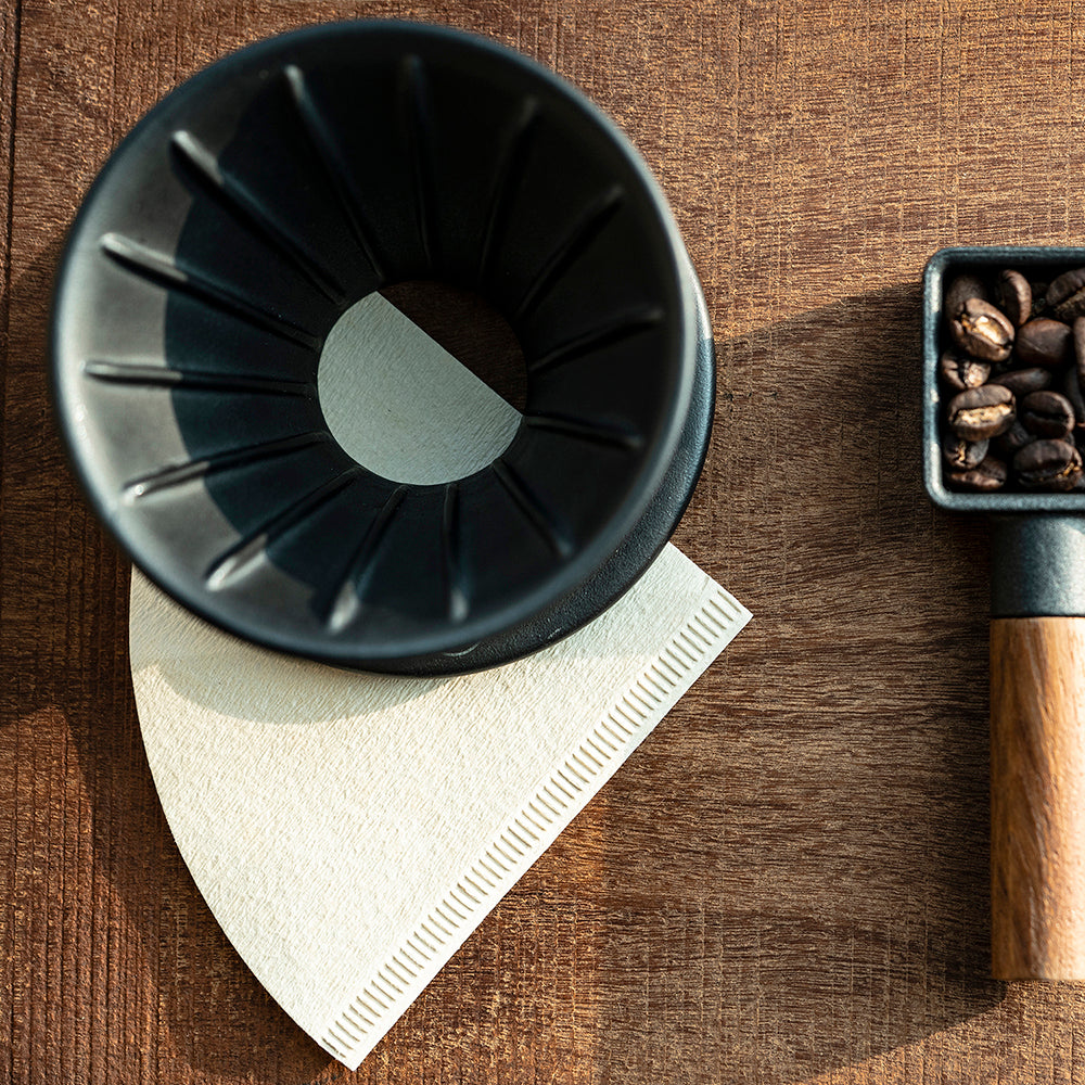 HMM ceramic coffee dripper and cast iron coffee scoop.